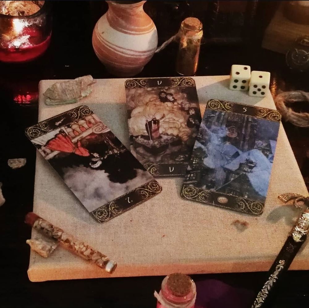 Dice, cards and potion bottles laid out on a table